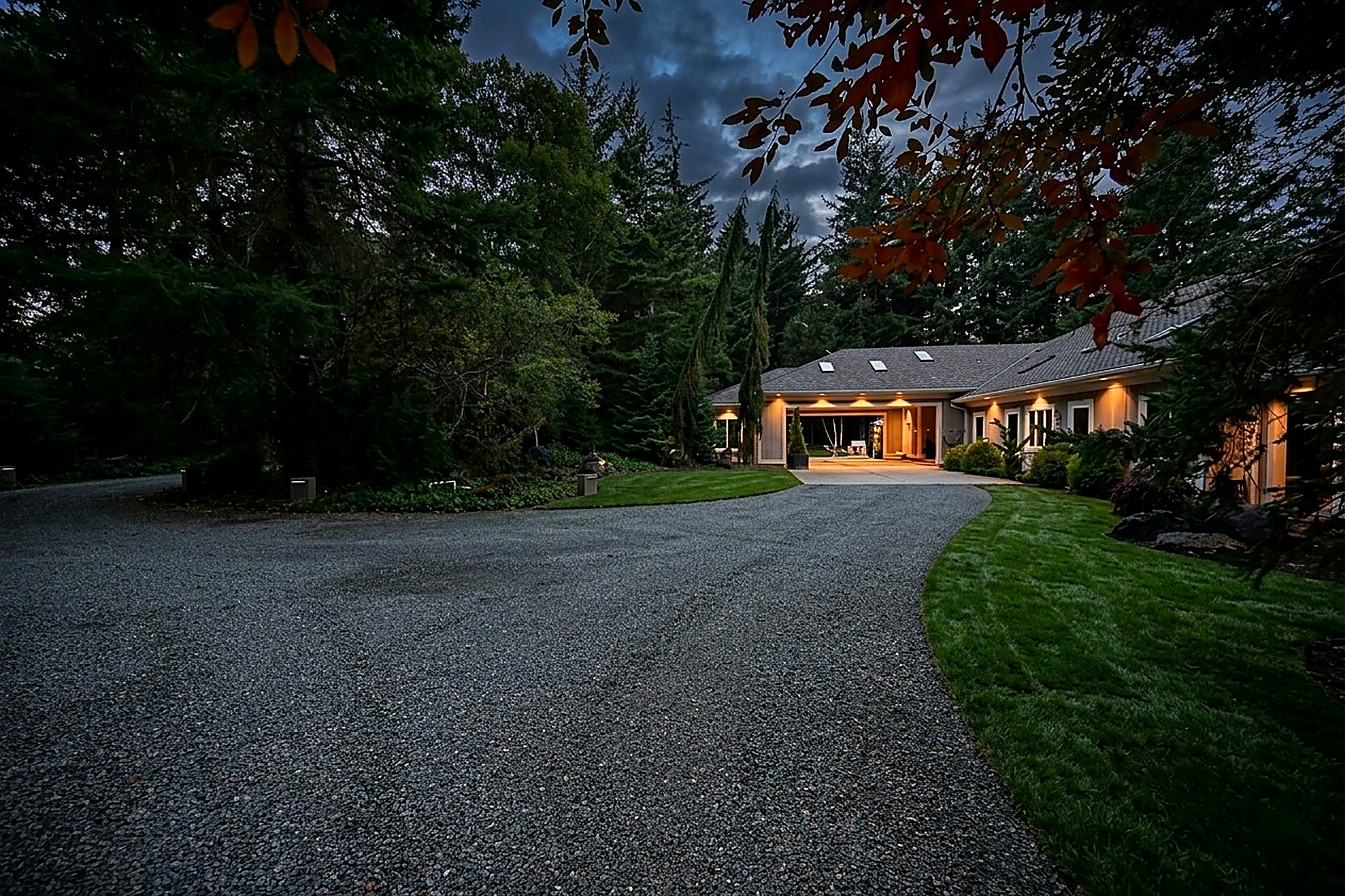 The Bandon House at dusk beneath old-growth pines