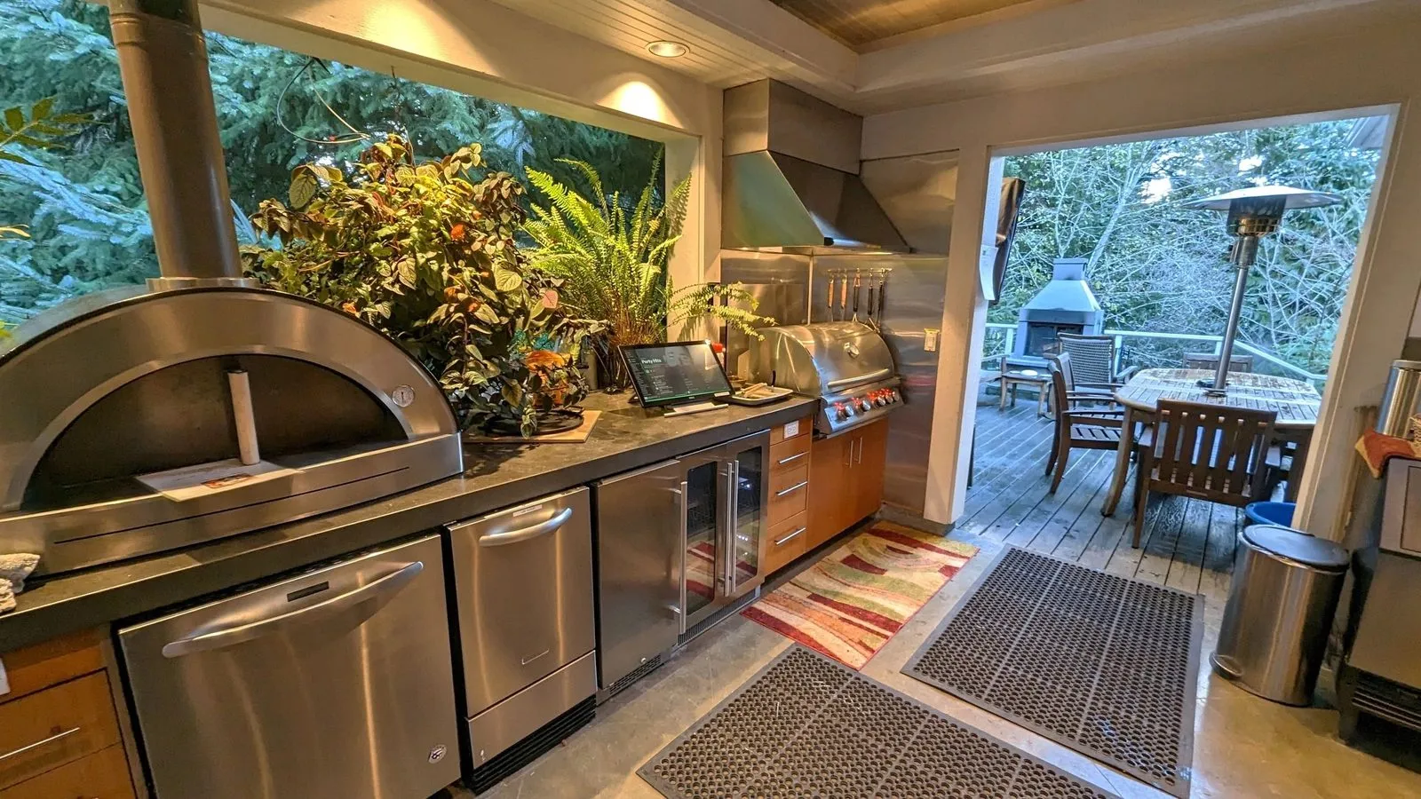 Outdoor kitchen with wood-fired pizza oven and grill